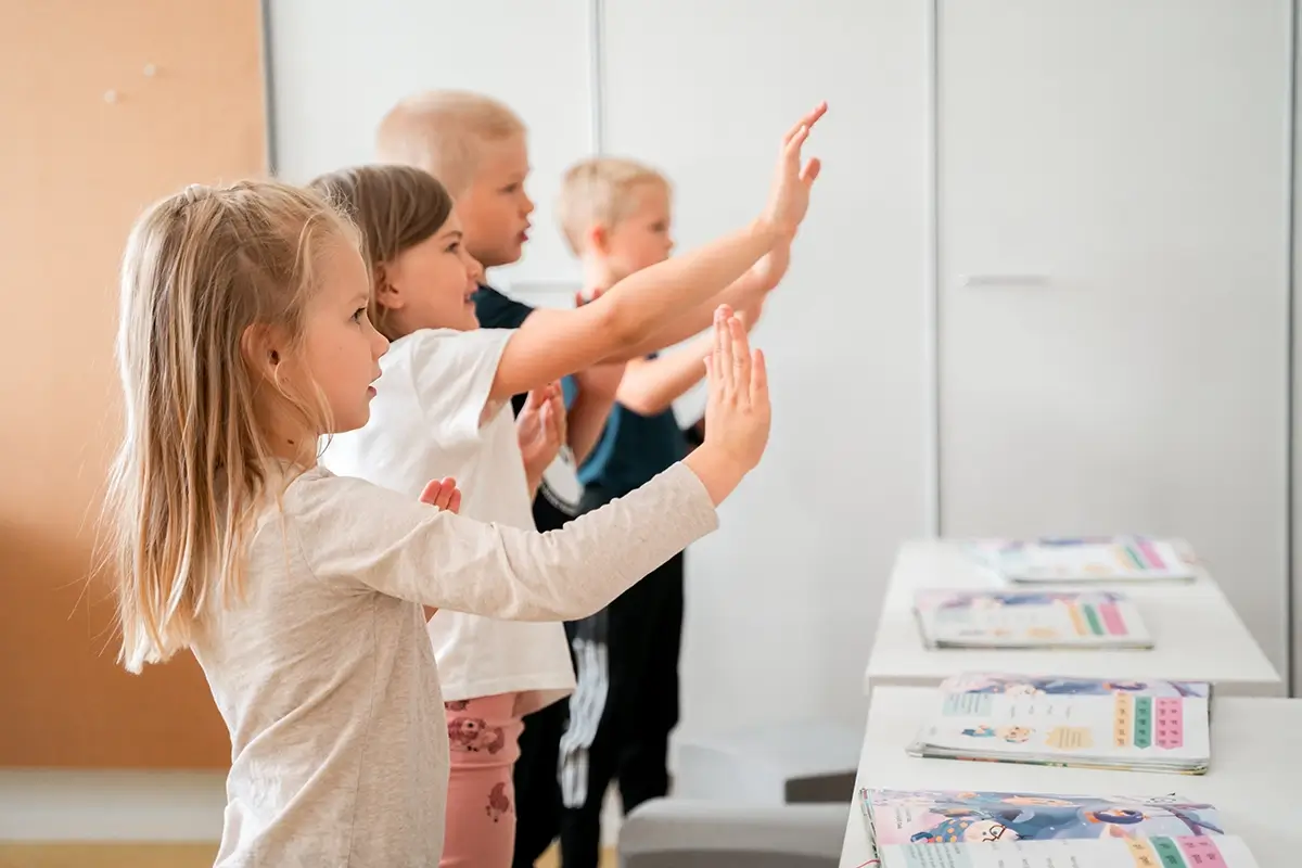 Children and teachers taking part in a Geego movement moment