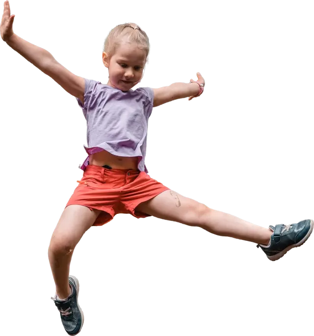 A child practising jumping in a school gym